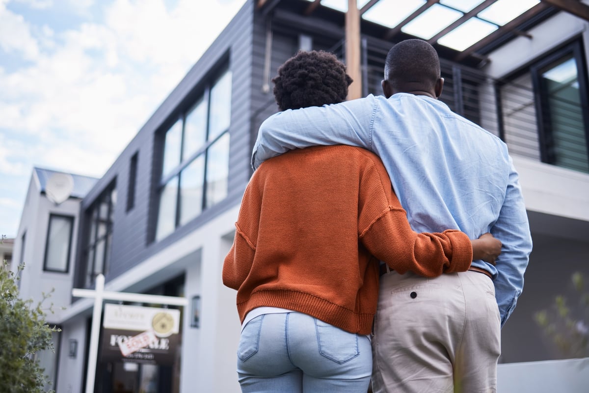 Homeowners standing in the neighborhood of their dreams